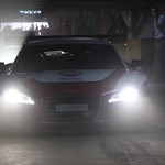 #22 re-enters the team's base - in a dark, multi-storey car park.